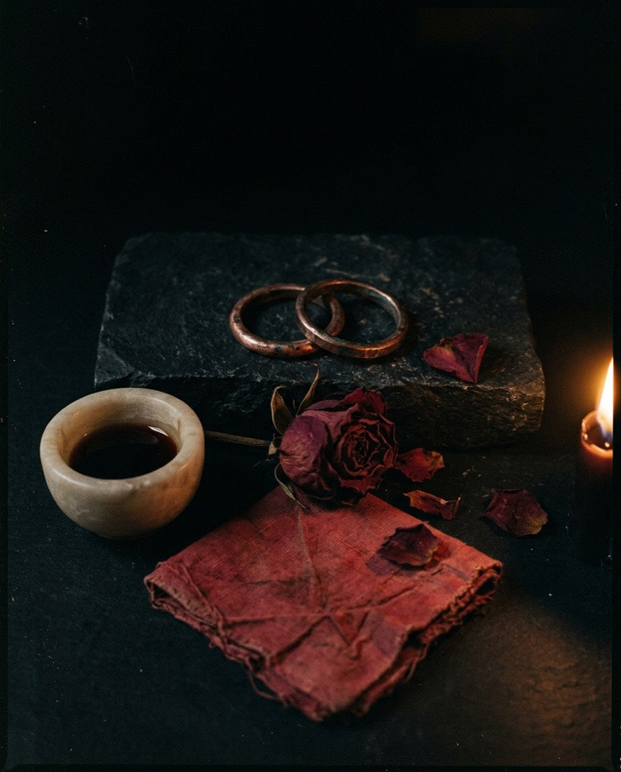 Red candle and rose petals for a working of the heart