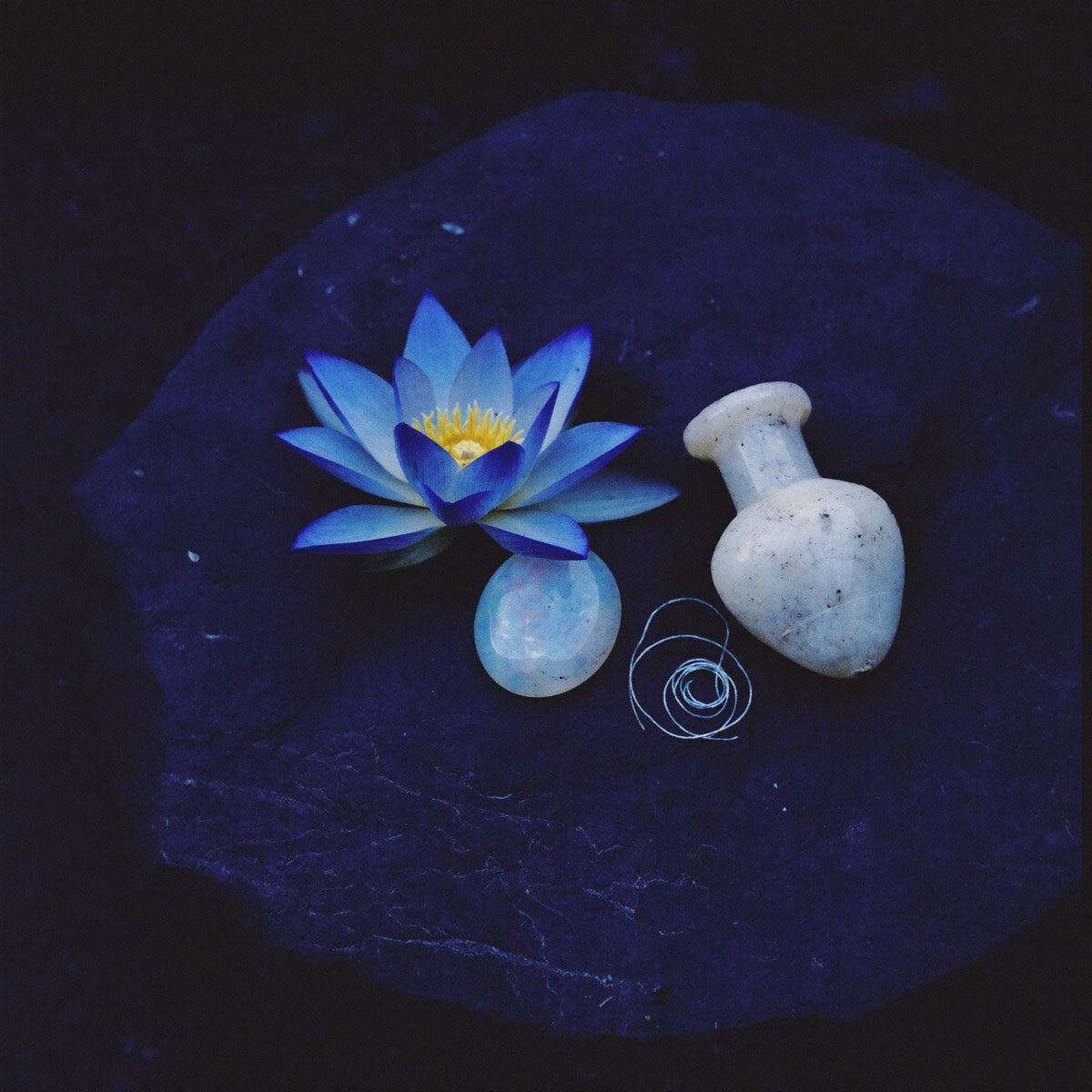 Papyrus scroll and scrying bowl on a dark altar